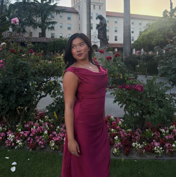 Yu-Tong looking over her shoulder in rose garden